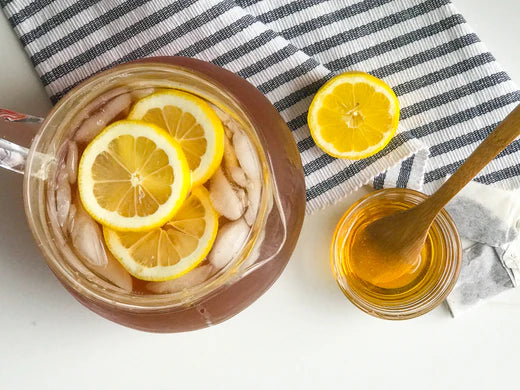 pitcher with lemon iced tea and honey