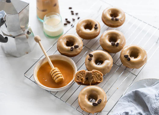 tray of donuts with dish of honey