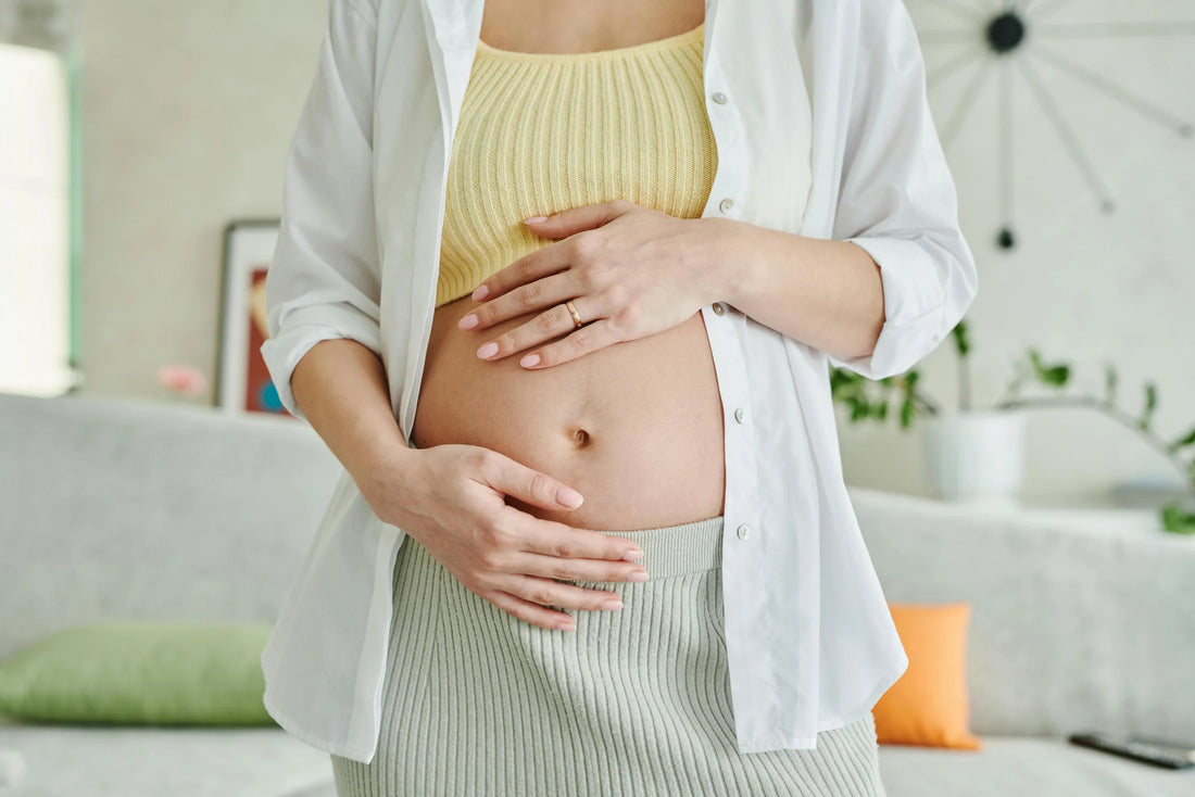 pregnant woman holding stomach