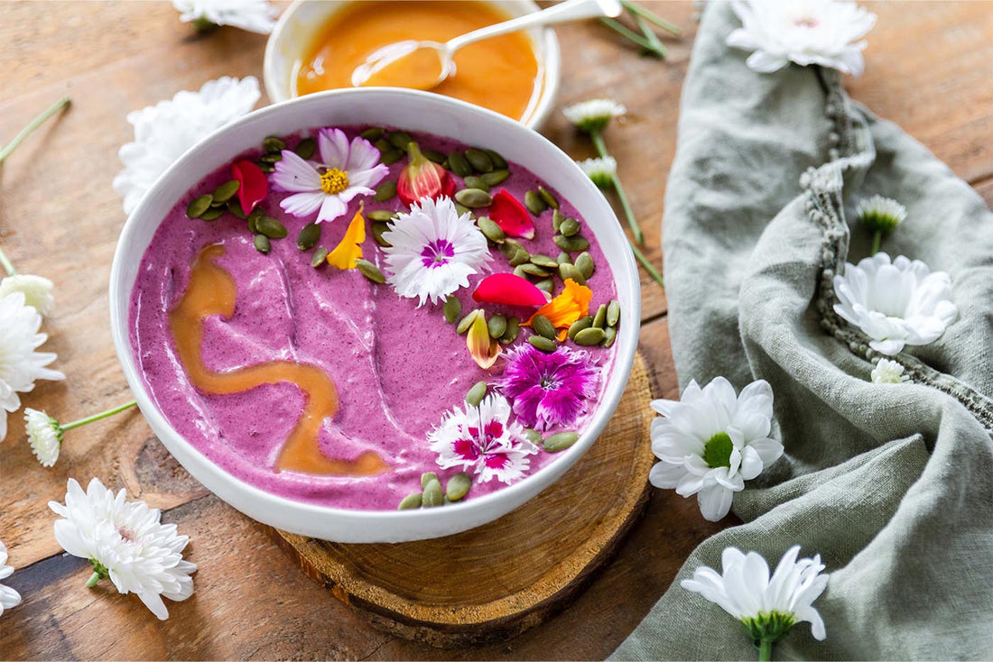 Pink smoothie bowl with flower decorations