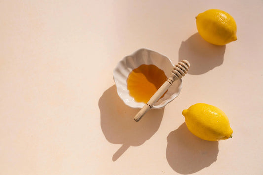 lemons and bowl of honey with honey dipper